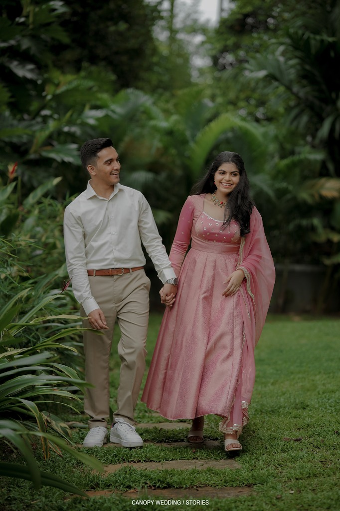 Chris and Chinnu walking together in a garden